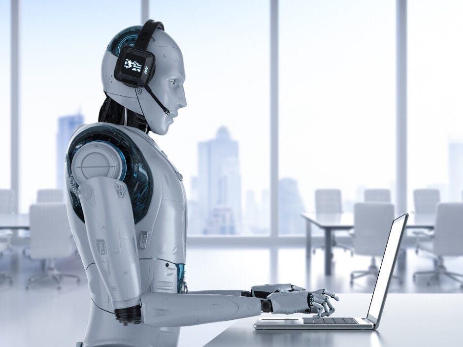 An AI robot answers calls on a laptop in a clinical white office. It is the only one there; the other tables and chairs are empty.