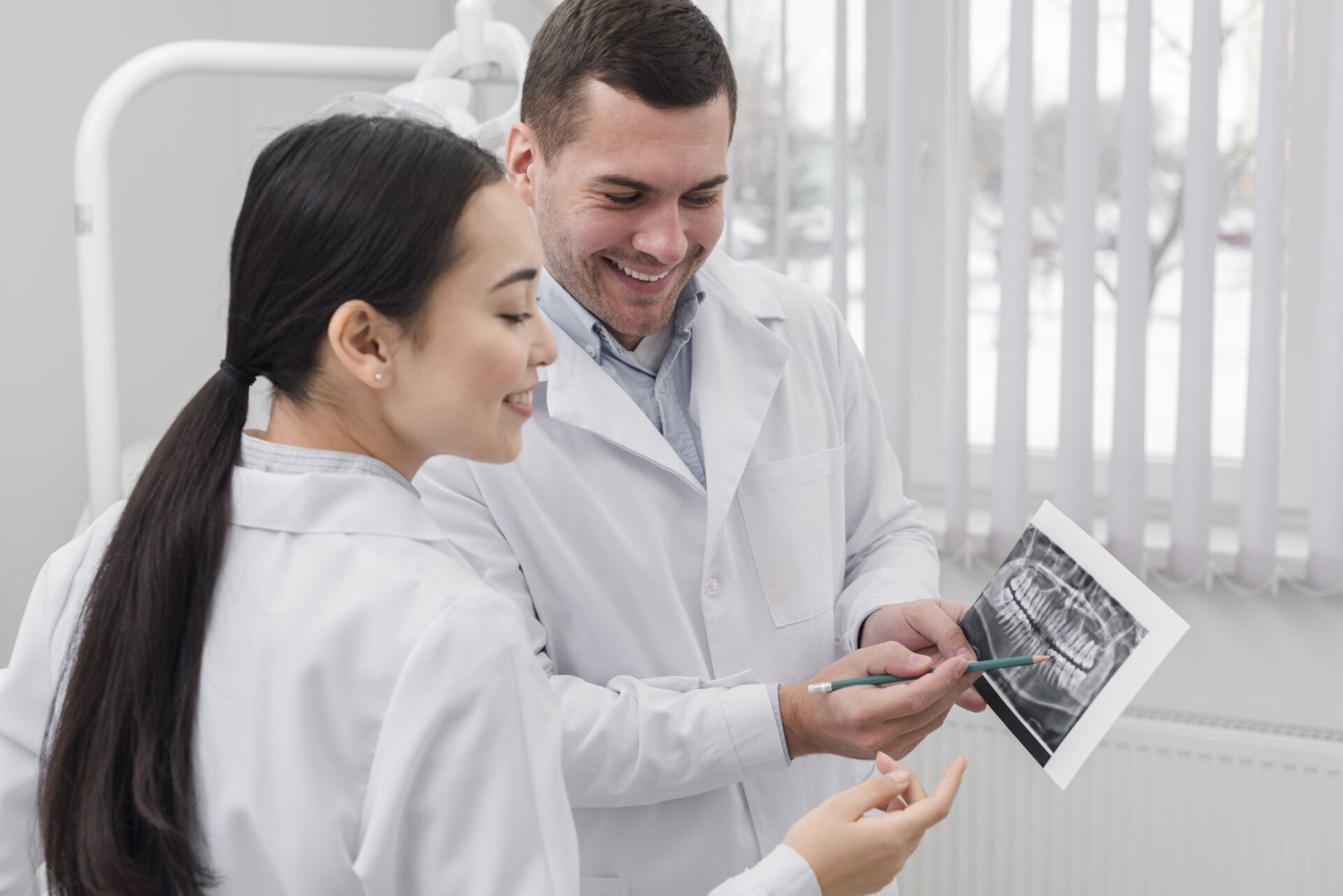 male and female dentists looking at a scan