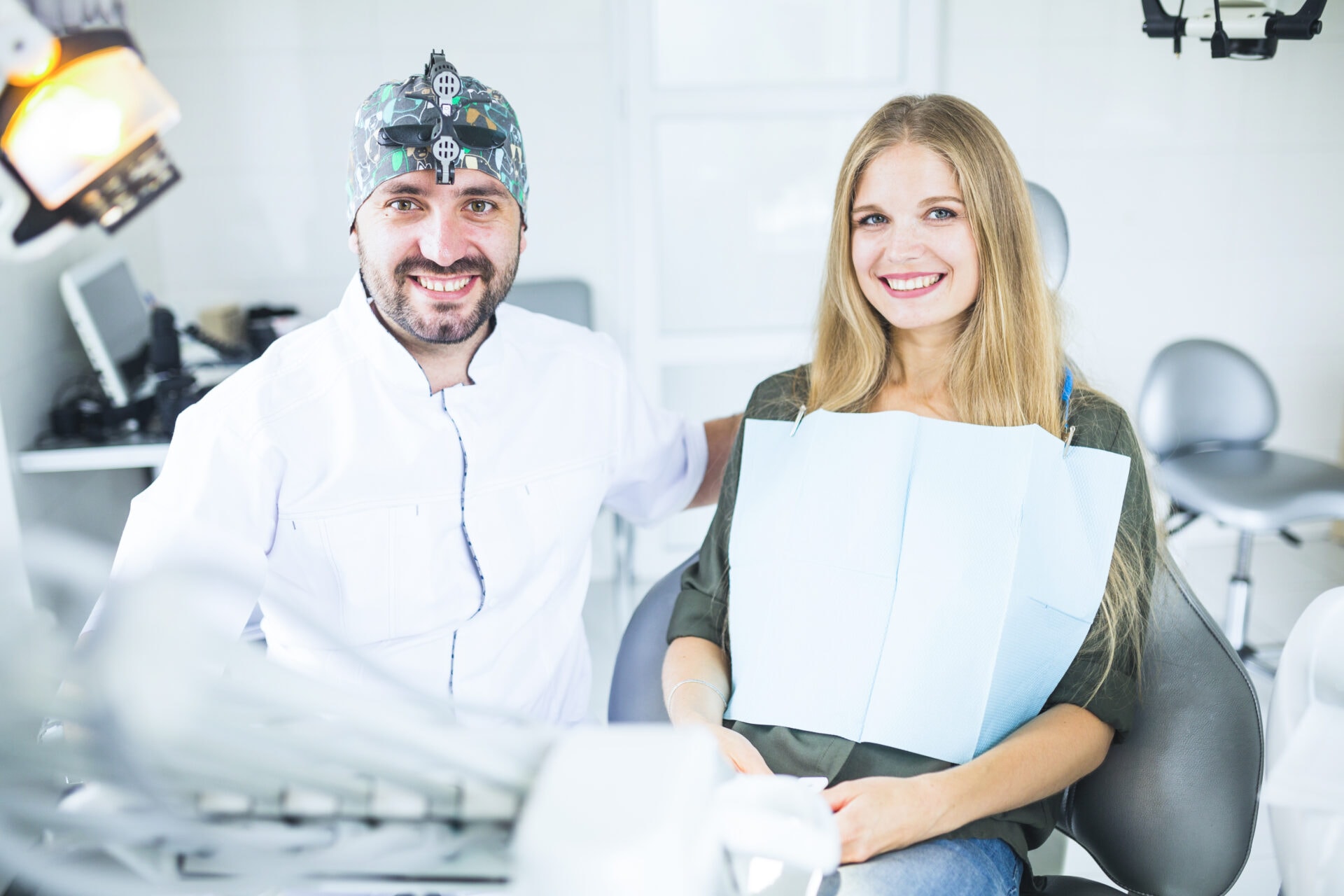 portrait happy male doctor with female patient