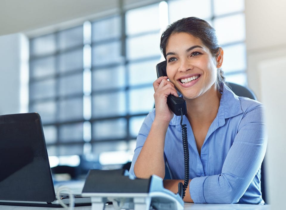 Dental team member calling a patient to schedule overdue treatment